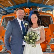 Lifeboat volunteers Neil Davies and Monika Lewandowska married in Norwich before stopping at the Cromer RNLI end of pier station for pictures on the way to their reception