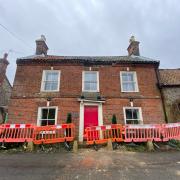 The B1110 The Street through Thornage in north Norfolk is closed after bricks and tiles fell from the front of a house, blocking the road