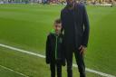 Alfie Oswick with dad Dan at Carrow Road.  Alfie was the community hero who carried out the match ball for the Norwich City game against Ipswich Town.  Pictures: Oswick family