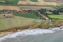 An image of Happisburgh from above. The proposed new car park would sit between the row of homes to the right, and the lighthouse on the left.