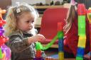 Two-year-old Ava playing with the marble run at the Buxton pre-school playgroup, which has received a 'good' Ofsted.