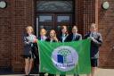 Cromer Academy students with the eco-schools flag