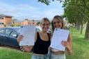 Reepham High School students Ruby Dowe (right) and Mia Starling holding up their GCSE results