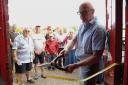 Richard Stuckey from the BBC's Repair Shop cutting the ribbon on the Cromer Community Shed