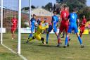 Sheringham Town player Jordan Forbes, far right, gets one past the Ely keeper.