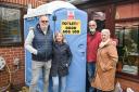 Flood-hit Staithe Road residents Steve and Susan Adkins with their neighbours William and Deanna Wells and their new portable toilet
