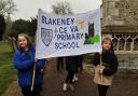 Pupils from Blakeney Primary School carrying their banner