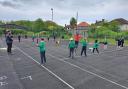 Primary school children learn tennis on a visit to Cromer tennis club