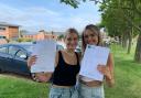 Reepham High School students Ruby Dowe (right) and Mia Starling holding up their GCSE results