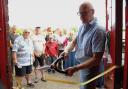 Richard Stuckey from the BBC's Repair Shop cutting the ribbon on the Cromer Community Shed