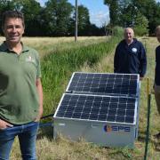 Jeremy Buxton (left) with his new solar-powered drinking water system at Eves Hill Farm near Reepham, along with Zac Battams (centre) and Ed Bramham-Jones from the Norfolk Rivers Trust