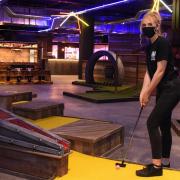 Imogen Addison, team member, checks the crazier golf course as the Boom Battle Bar at the Castle Quarter reopens.
