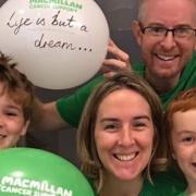 Chris Wright (42) with sons Patrick (nine) and Ben (seven), and wife Rebecca (41), getting to the 1,000km mark in their rowing challenge for MacMillan Cancer Support challenge
