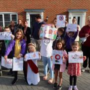 Youngsters and parents of Wilson Road in Stalham, where there a poster competition in the hopes of encouraging motorists to slow down.