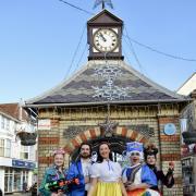 The cast of Snow White, who will take to the stage at Sheringham Little Theatre in December, at the town's clock tower.