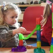 Two-year-old Ava playing with the marble run at the Buxton pre-school playgroup, which has received a 'good' Ofsted.