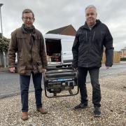 Duncan Baker, MP for North Norfolk, and Rob Scammell holding a power generator that will be delivered to Ukraine in February.