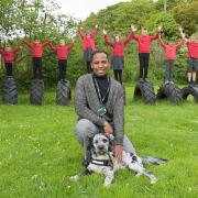 Antingham and Southrepps Primary School pupils jump for joy at the school's new 'good' Ofsted rating. Pictured front is head teacher Miles Elcock and one of the two school dogs.
