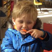 A youngster brushes his teeth at Worstead Preschool