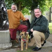 Berni Marfleet and Rev David Warner with dog Buddy at the site of the new sculptures