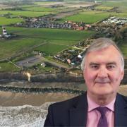 A senior councillor has said “NIMBYs” in a north Norfolk village need to “wake up” after plans to build a controversial new car park were given the green light