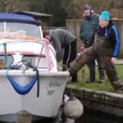 A police investigation has been launched after two fishermen were filmed swearing at a boater and kicking away his boat as he tried to moor at Irstead Staithe on the Norfolk Broads