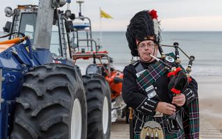 George Sinclair playing the bagpipes outside Sheringham Lifeboat Station