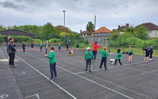 Primary school children learn tennis on a visit to Cromer tennis club