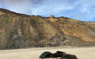 A home in Trimingham on the Norfolk coast is set to be demolished by the council after being left hanging perilously over a cliff edge following a cliff fall